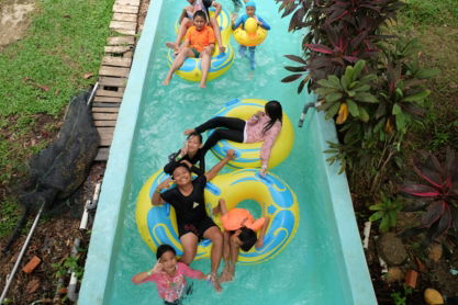a-group-of-people-riding-on-top-of-an-inflatable-raft.jpg a group of people riding on top of an inflatable raft